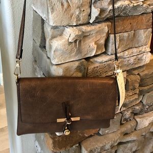 An adjustable brown vegan crossbody purse